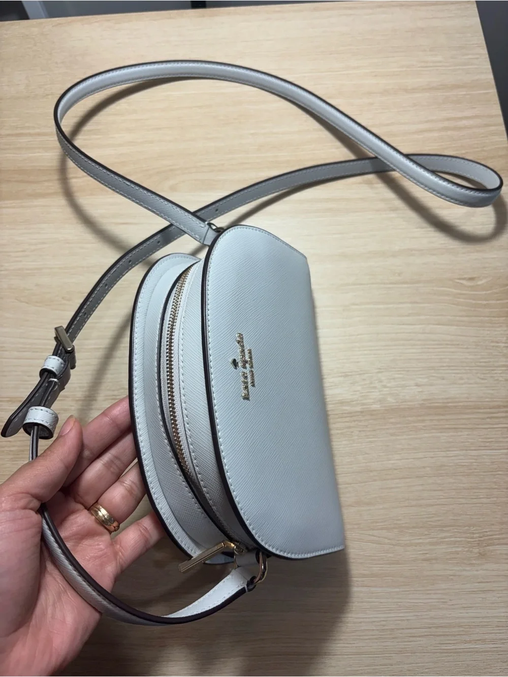 kate spade cream dome crossbody with gold logo